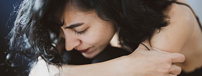 woman hunched over frustrated and stressed