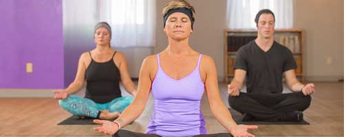 three people practicing mindfulness with sleepphones headphones